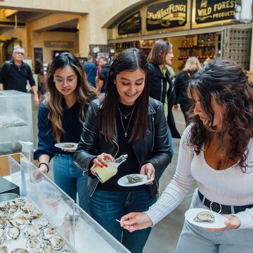 Students select oysters at a booth at the SF Ferry Building.