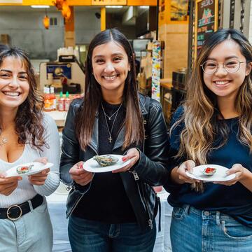 Three students show their oyster selections at SF Ferry Building.