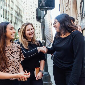 Students chat on a downtown street