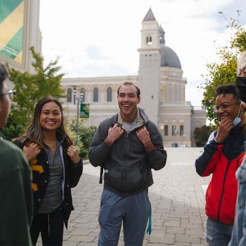 A group of students talk near St. Ignatius Church.