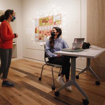 Student and staff discuss installation at Thacher Gallery.