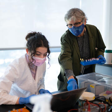 Professor helps a student in the lab.