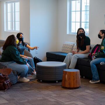 Students talk in a common area of the dorms.