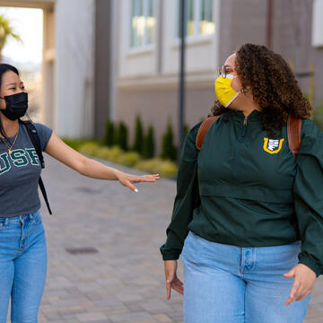 Two students talk outside the Lone Mountain dorms.