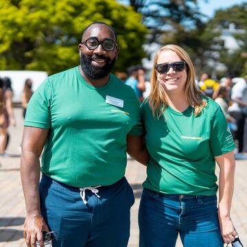 Two staff members pose for a photo.