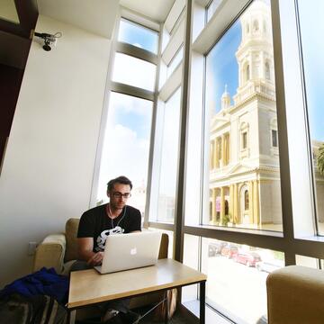 Student studies in front a a window in Zief Library.