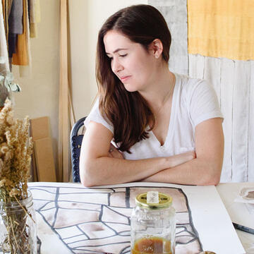 Sofia V. Gonzalez looks over a table of art supplies