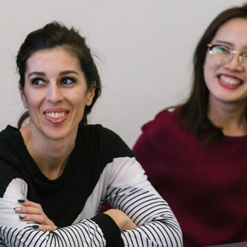 Two students sit next to each other in classroom