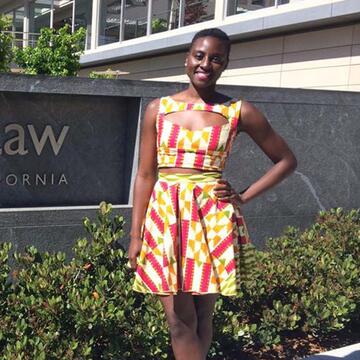 Akofa Tsiagbe stands in front of a sign for Berkeley school of law.