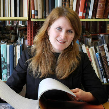 Aubree Mladenovic looks at books in the library.