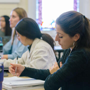 Students writing in classroom.