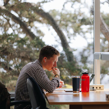 Student studies at a table in the library.