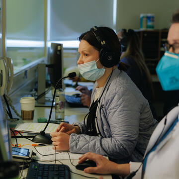 Nursing faculty watch students in the sim lab from a control room.
