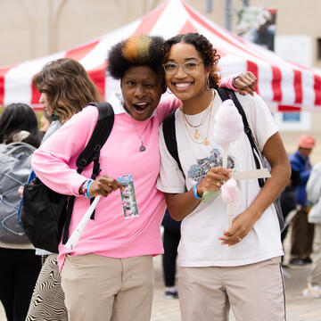 Two students pose and hug at the CAB carnival.