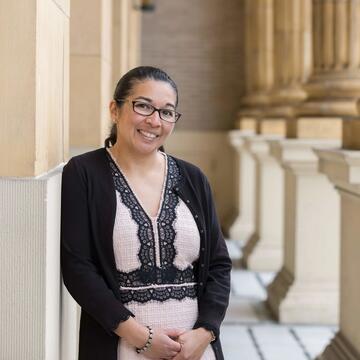 Sonya Arriola stands in front of church and poses for picture