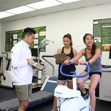 Students using an exercise bike