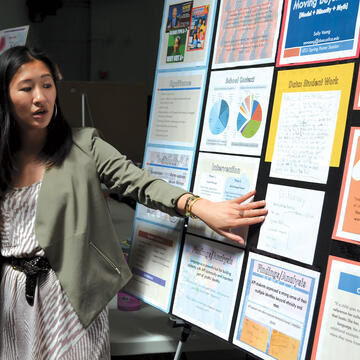 Teacher pointing to content on a board.