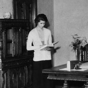 Claire Weidenmuller studying in a parlor, 1933.