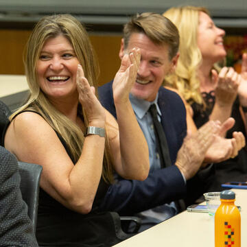 Alumni clapping for the speaker at an event