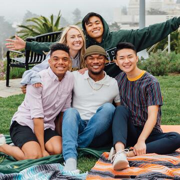 Five students on picnic blankets