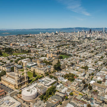 USF campus with San Francisco skyline in background.