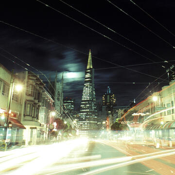 Light streaks illuminate a San Francisco street at night.