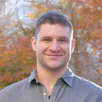 Nick Stagnaro headshot in front of autumn leaves changing colors