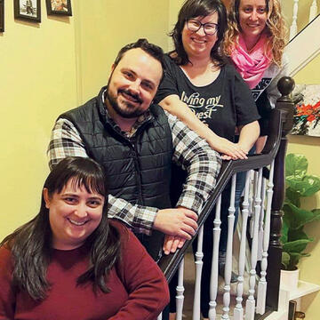 USF Alumni reunite on the staircase in one of their homes for a photograph