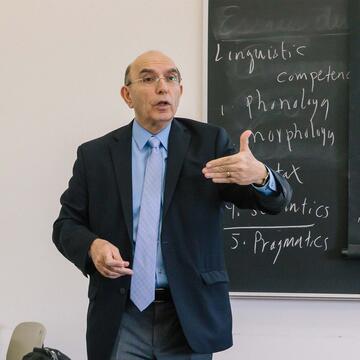 Teacher delivers a lecture in front of a class