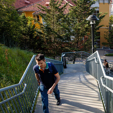 student walking up loyola village steps