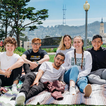 USF students sitting on picnic blanket on Lone Mountain