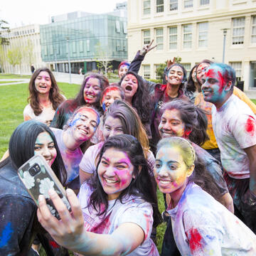 Students take a selfie during Holi Festival of Color at USF