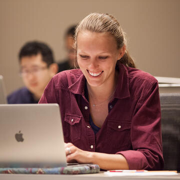 Student sitting with their laptop.