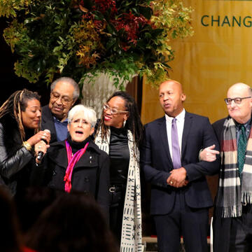 Jenn Johns, Clarence B. Jones, Joan Baez, Lateefah Simon,  Bryan Stevenson, and Jonathan Greenberg singing “We Shall Overcome.” 