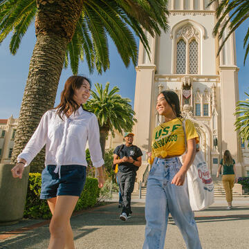 students laughing and walking together on Lone Mountain