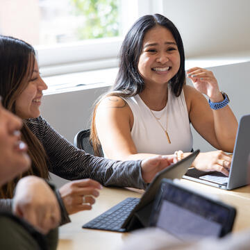 students gathered around a table in class