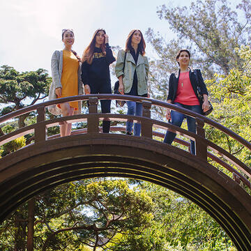 group of students stand on a bridge at the japanese tea garden in golden gate park