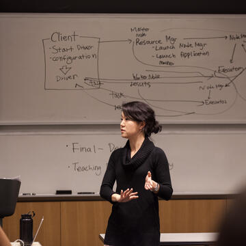 Professor teaching in front of a whiteboard