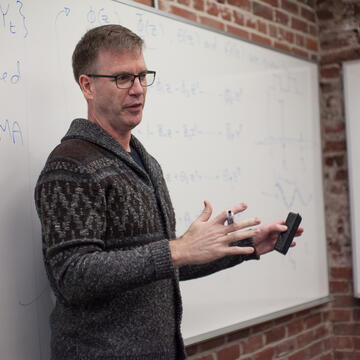 Professor teaching in front of a whiteboard