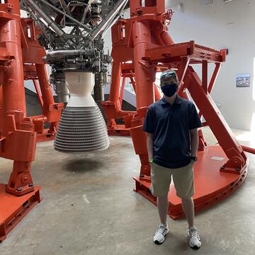 Joshua Cleary in front of a rocket