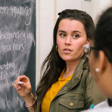 Faculty and student at chalkboard