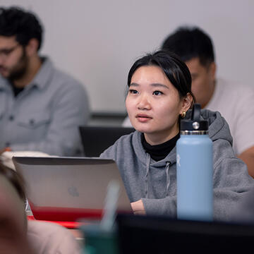 student listening to lecture in classroom