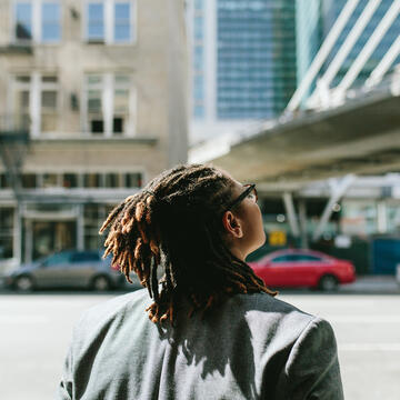 student looking up at sky in downtown san francisco