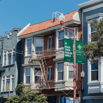 San Francisco apartments and a USF banner on a streetlamp
