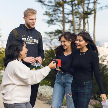 Four USF students hanging out on Lone Mountain