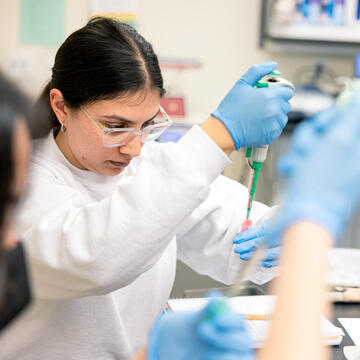 student using lab equipment