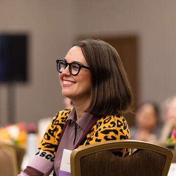 woman laughing during an event