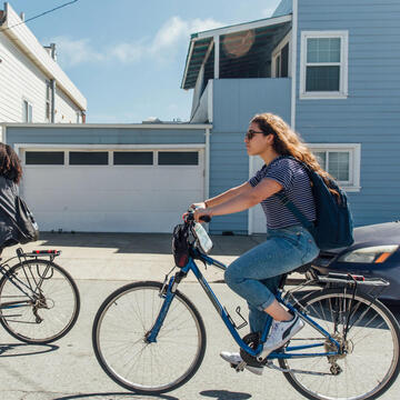 USF student biking on street of San Francisco