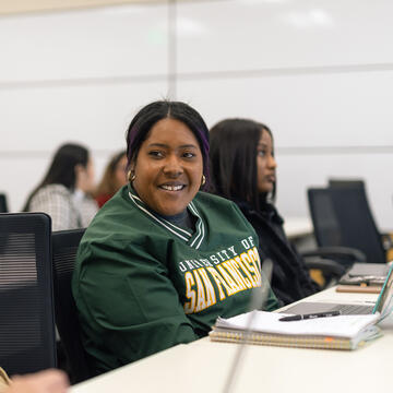 student smiling in classroom