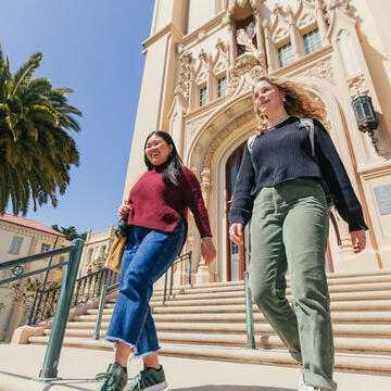 Two students walk down the stairs on Lone Mountain.